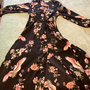 Floral black dress with a slit that goes down the leg. Long sleeve.